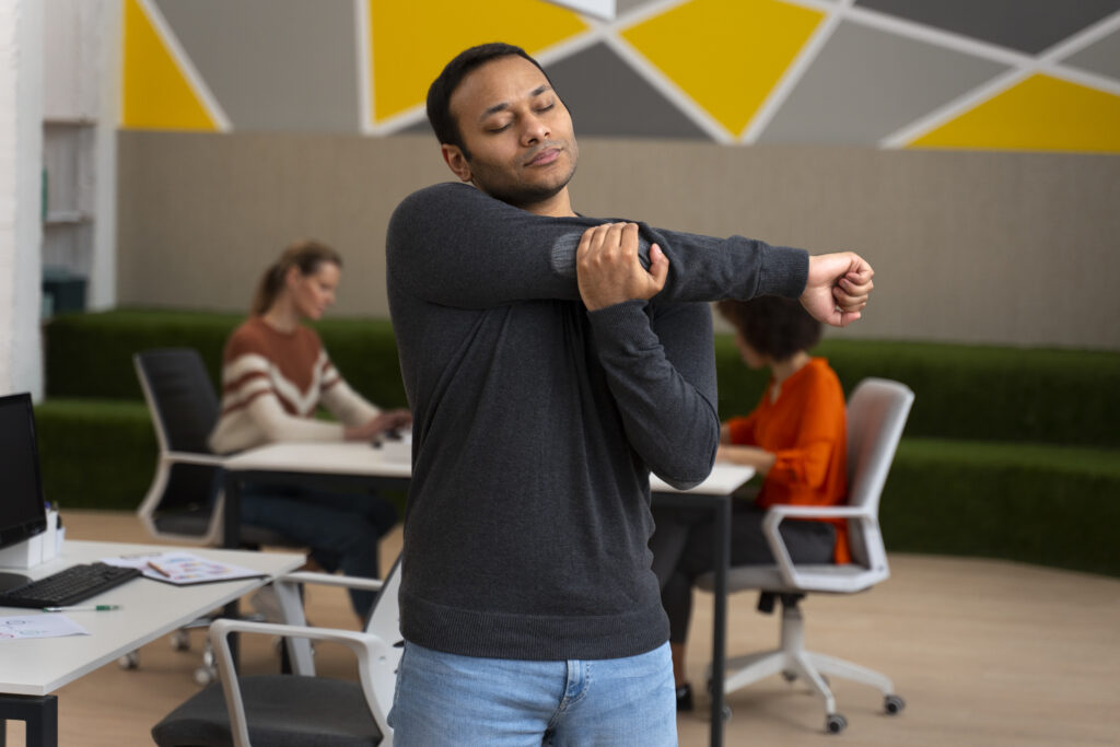 man-office-stretching-work-day