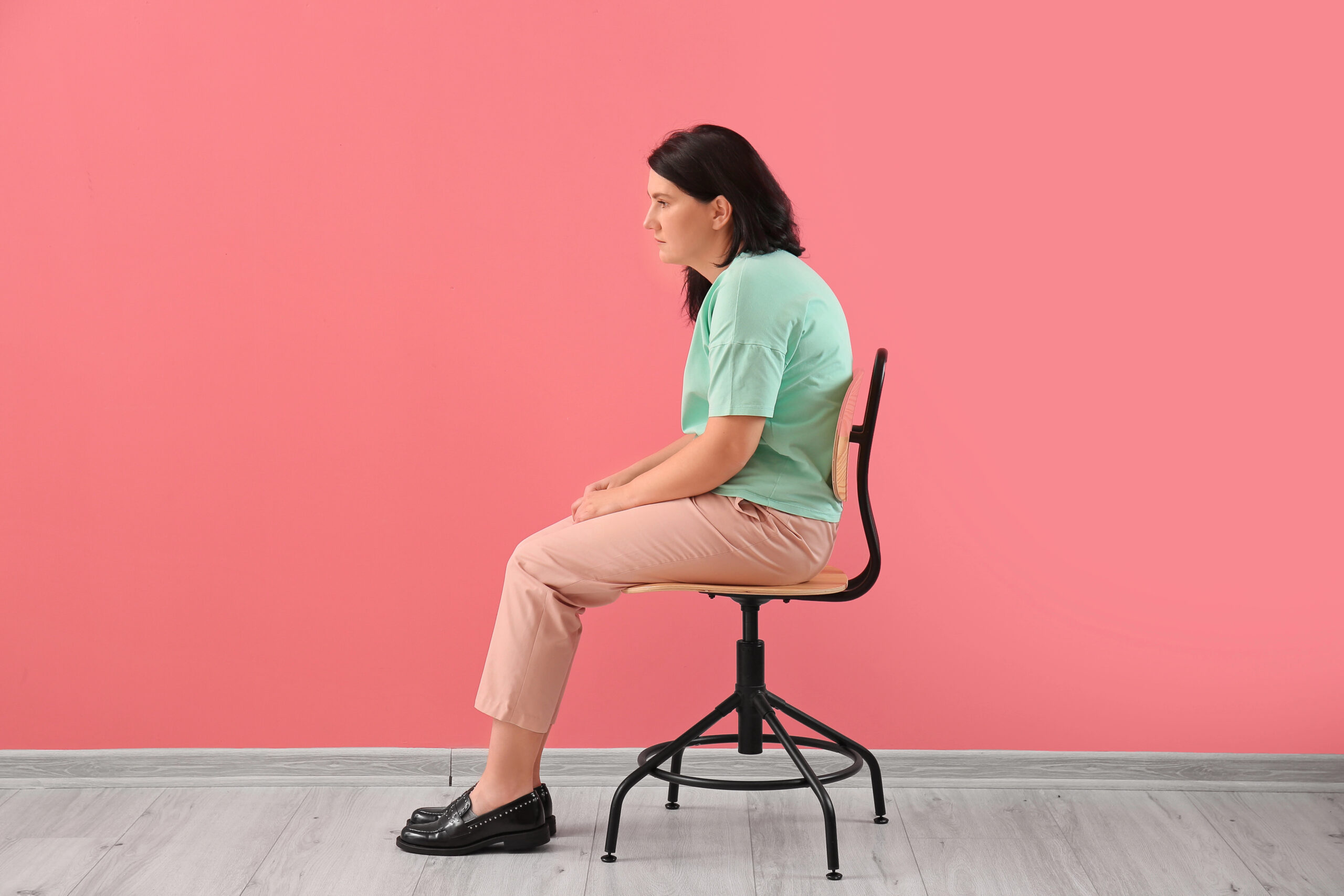Woman demonstrating poor shoulder posture while sitting